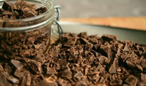 bowl of chocolate with chocolate shavings around it.