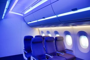 Airplane interior with blue lighting.