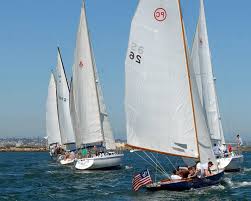 A few small sailboats moving around in the ocean.