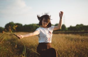 Young person playing in a field.